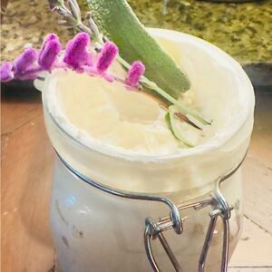 Herbal infused body butter in glass jar